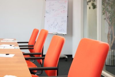 Decorative picture: orange chairs in the conference room of DAASI International